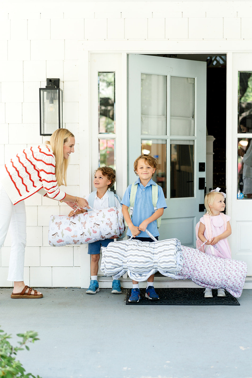 Mother with her children before school holding their nap mats! 